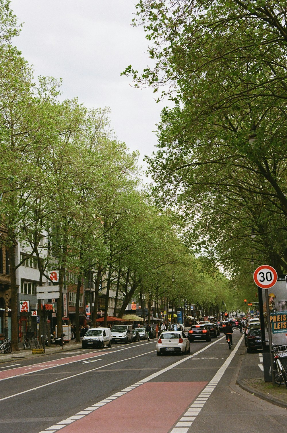 a city street with cars parked on the side of the road