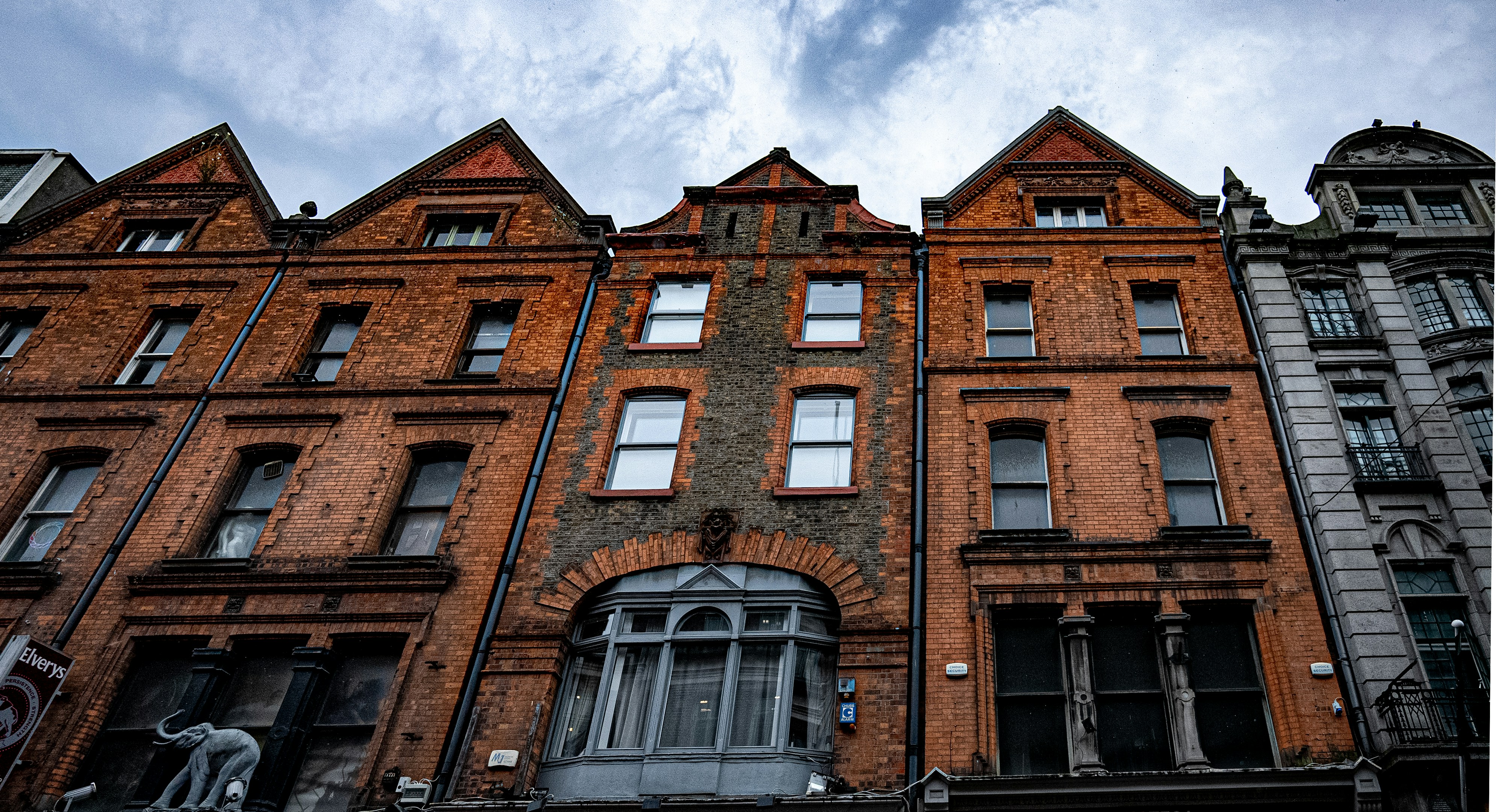 a tall brick building with many windows, 