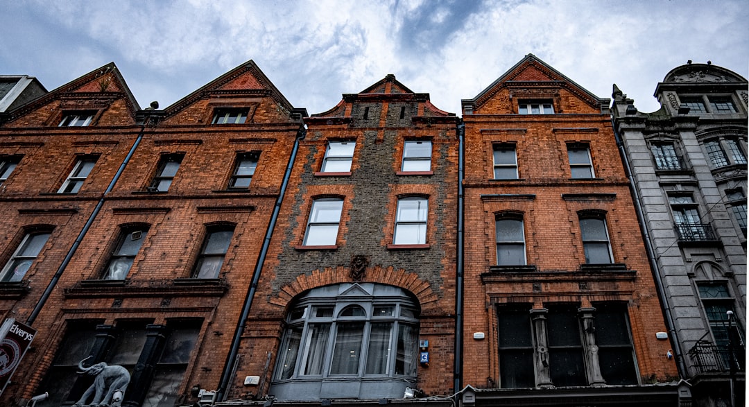 a tall brick building with many windows,