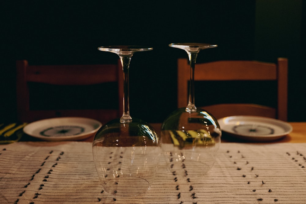 two wine glasses sitting on top of a table