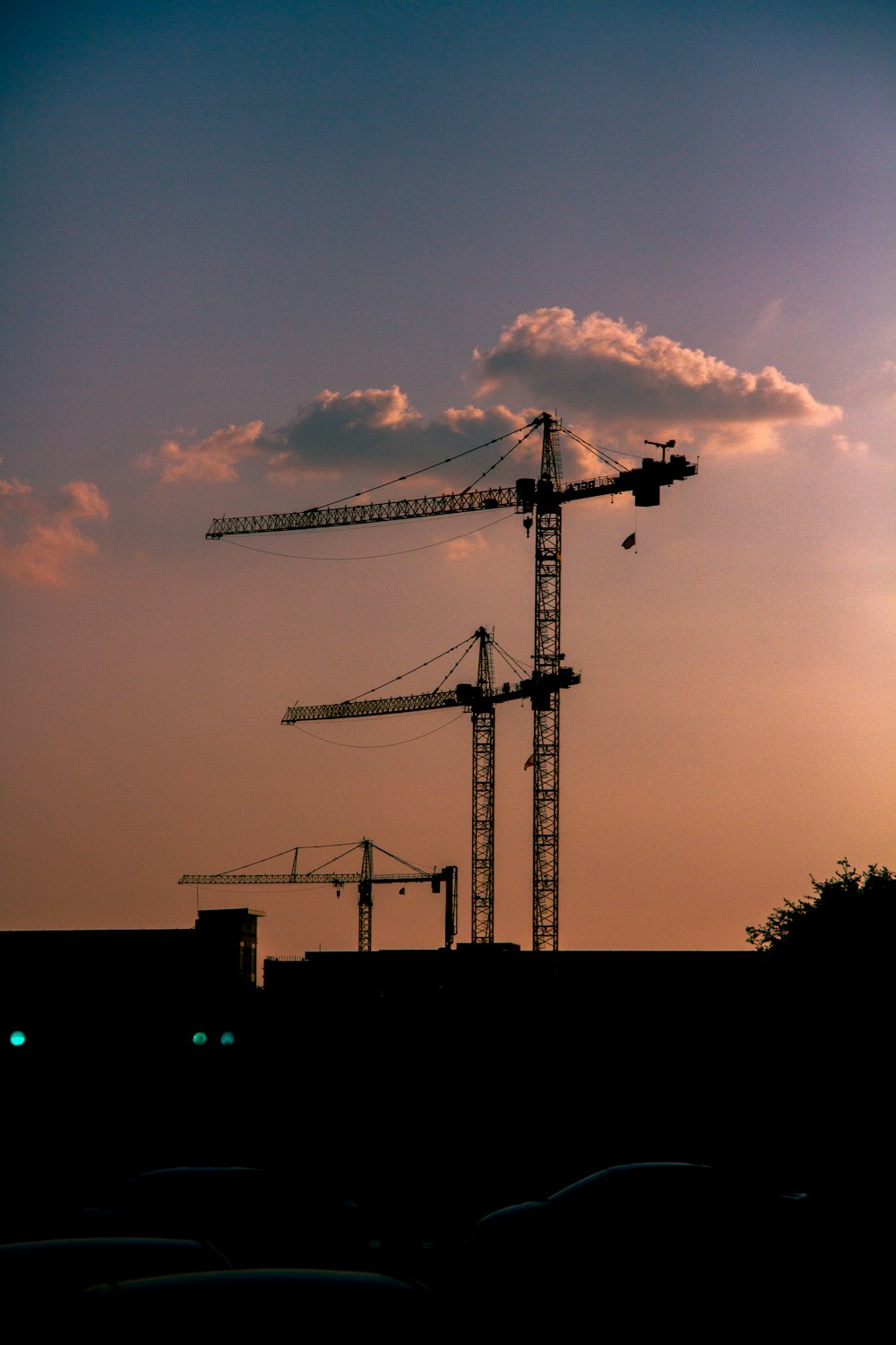 a crane is silhouetted against the evening sky