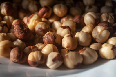 Close-up of rich chocolate-coated cashews gleaming under soft lighting.