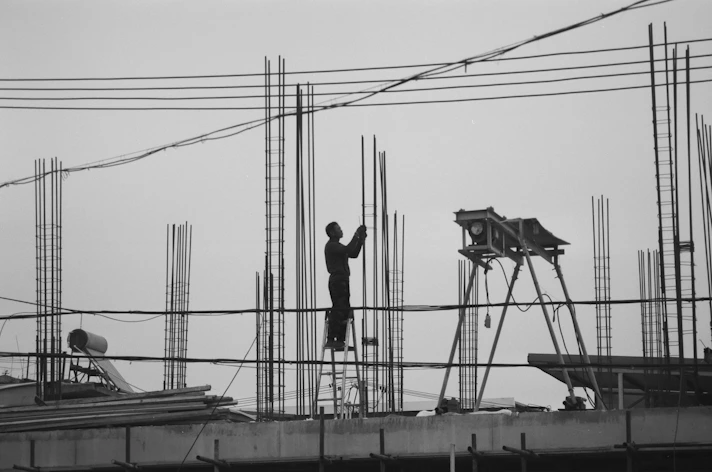 a man standing on top of a building under construction