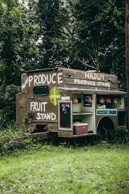 a food truck parked in the middle of a forest