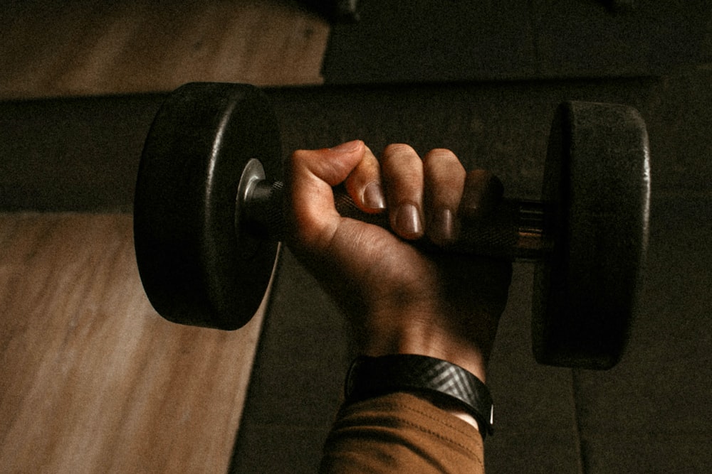 a person lifting a barbell in a gym