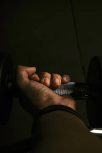 Close-up of hands gripping weights, showing determination.
