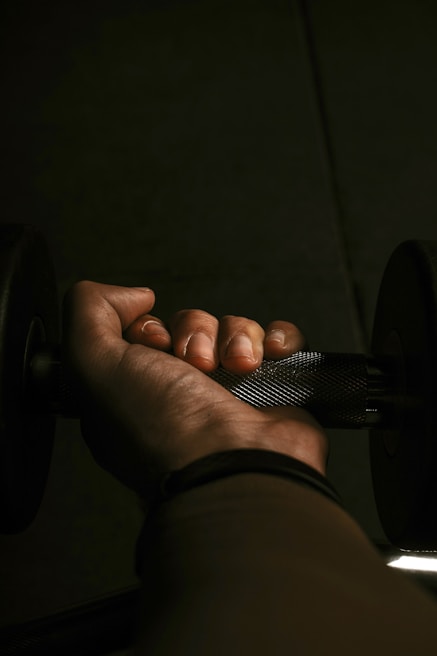 Close-up of hands gripping dumbbells for a home workout session