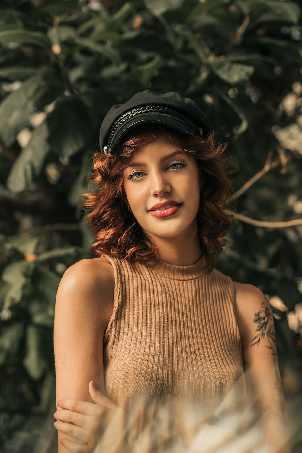 a woman with red hair wearing a hat