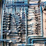 Wide shot of a team fixing a complex network of pipes in a commercial building.