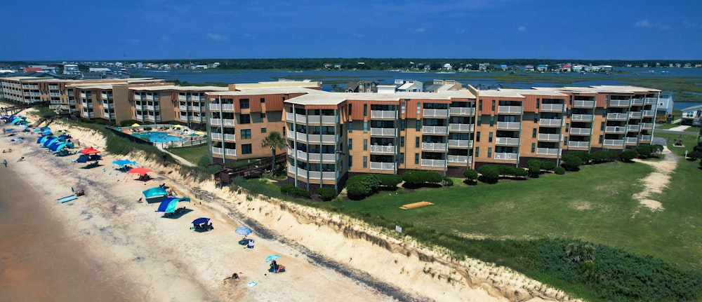 an aerial view of a beach with a hotel in the background