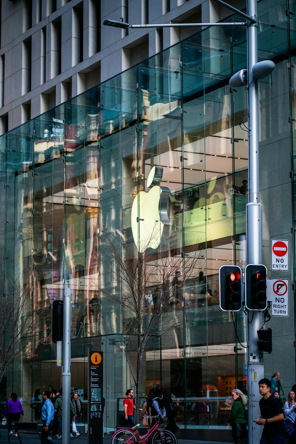 a reflection of an apple store in a glass building