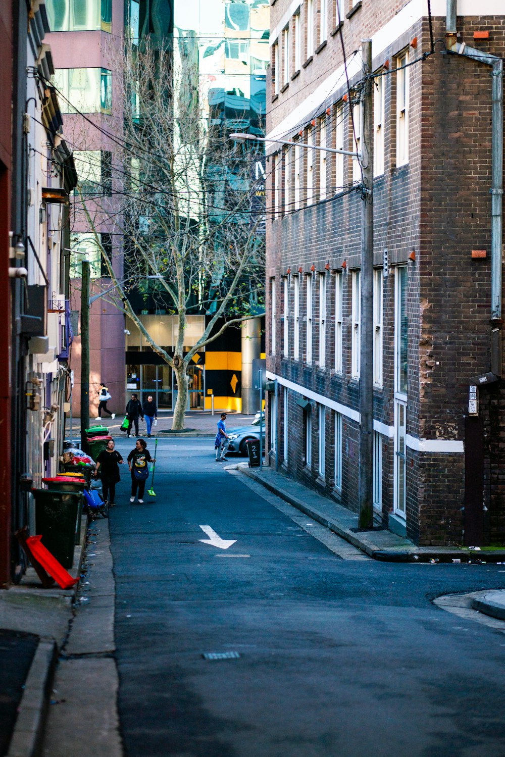 a narrow city street lined with tall buildings