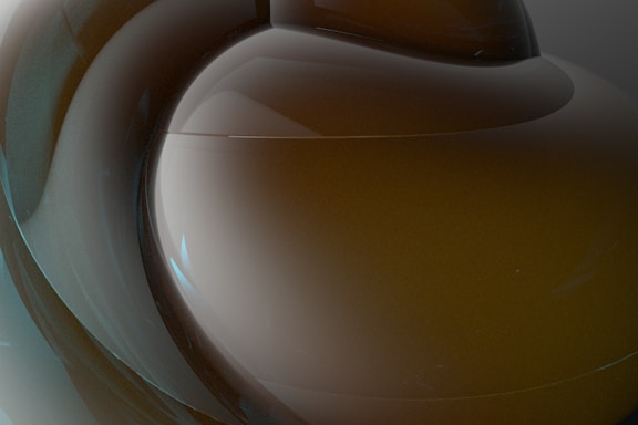 Close-up of a sleek, minimalist sculpture with smooth curves and subtle shadows.