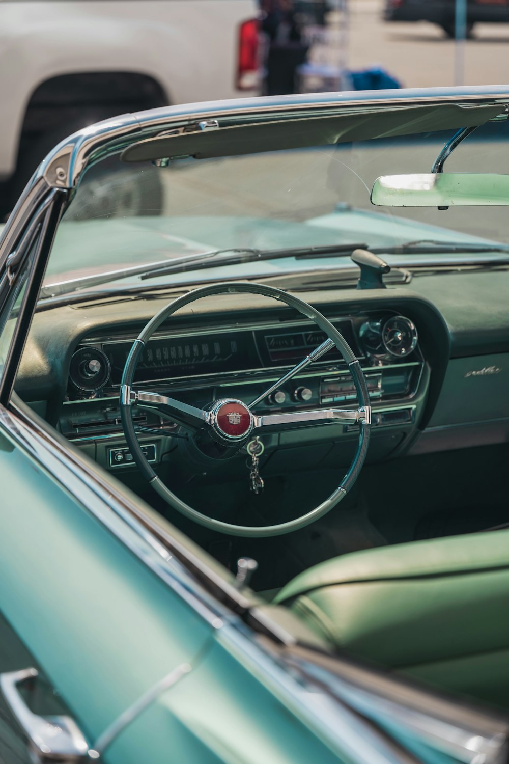 a green car with a steering wheel and dashboard