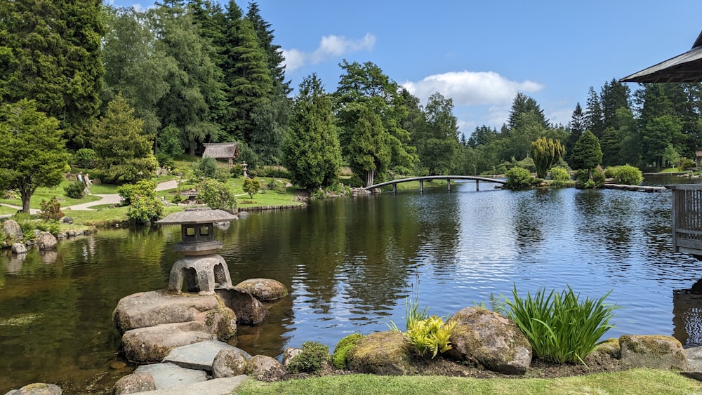 a pond with a bridge in the middle of it