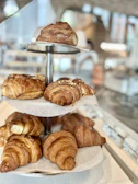 Delicate pastries displayed on a tiered stand in a cozy café setting.