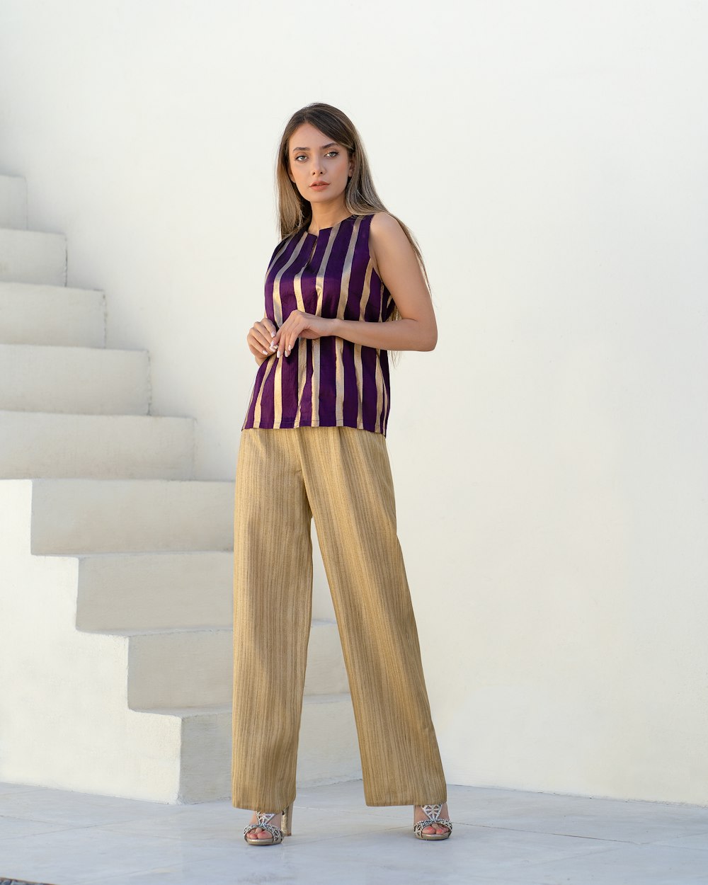 a woman standing in front of a set of stairs