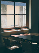 A warm, Scandinavian-style restaurant scene with a rustic wooden table set for a meal, sunlight streaming softly through a window.