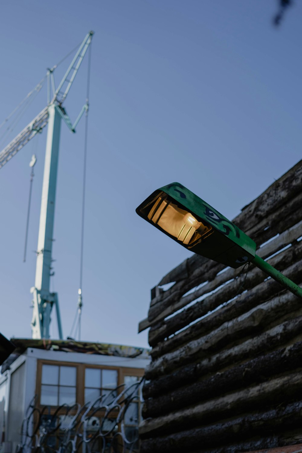 a street light sitting next to a pile of wood