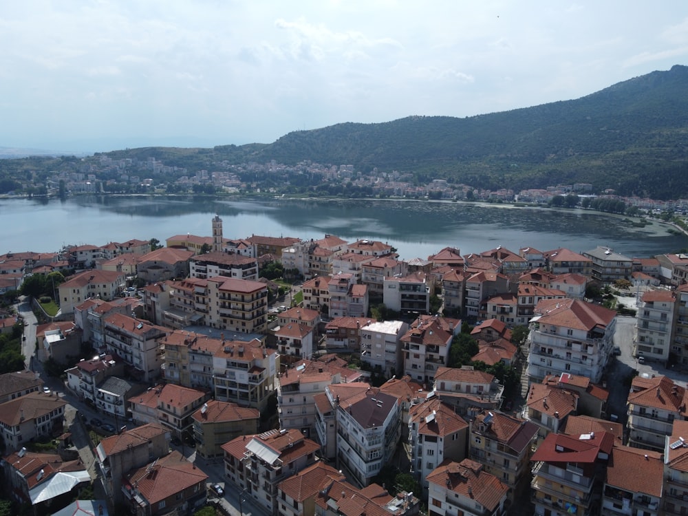 an aerial view of a city with a lake in the background