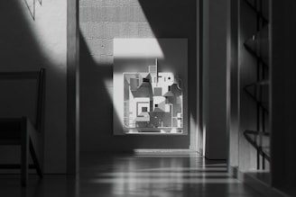 Minimalist black metal frame showcasing modern artwork in a bright office setting.