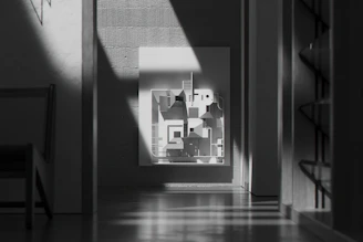 Elegant minimalist print with fine lines and soft shadows displayed in a bright room.