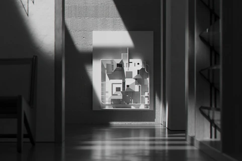 Elegant minimalist print with fine lines and soft shadows displayed in a bright room.