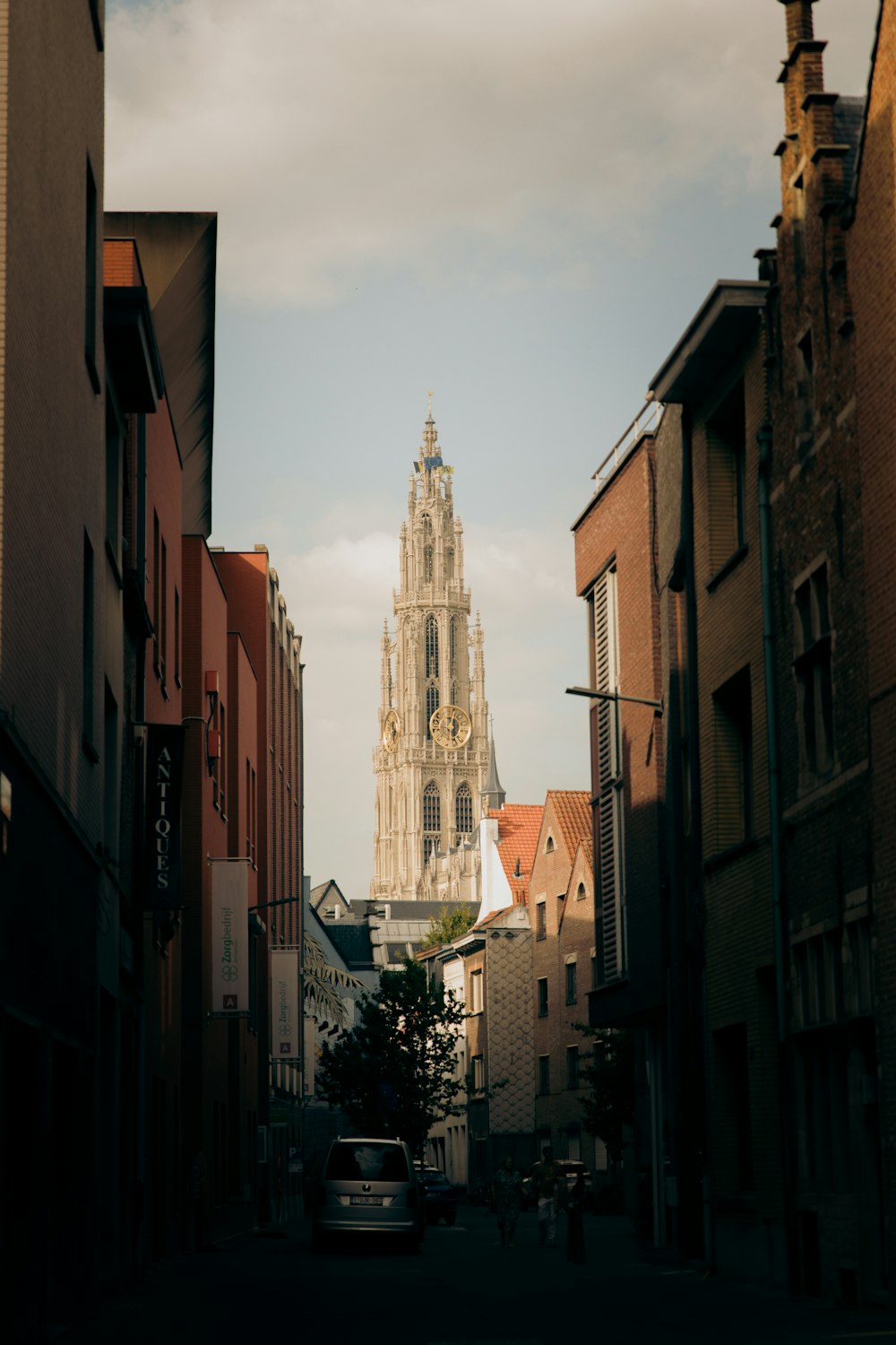 a tall building towering over a city next to tall buildings