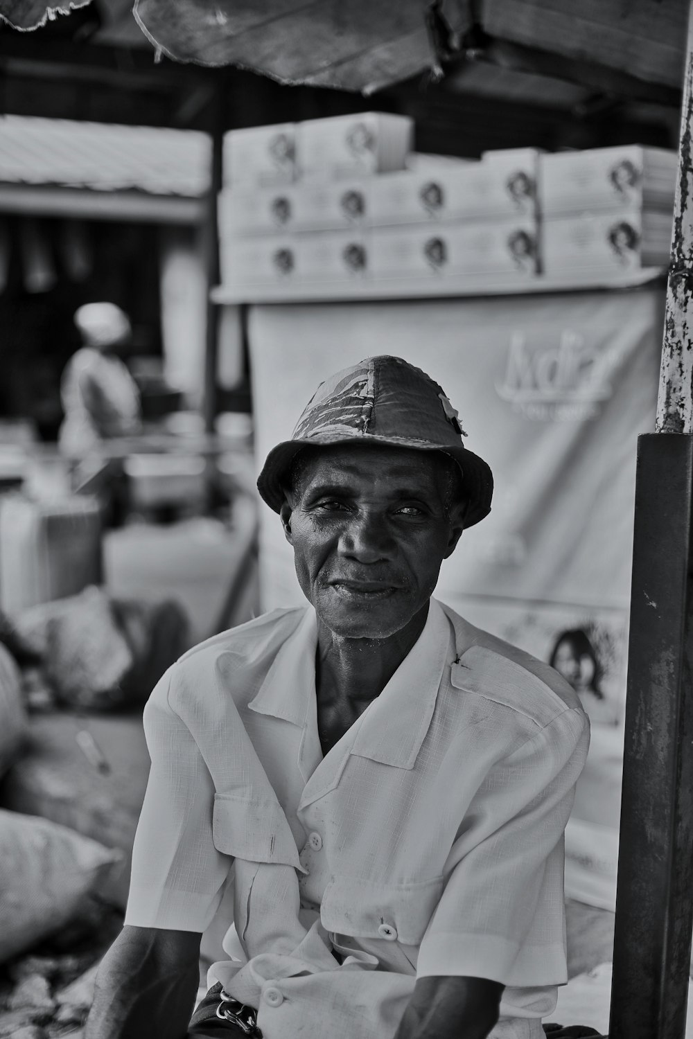 a black and white photo of a man wearing a hat