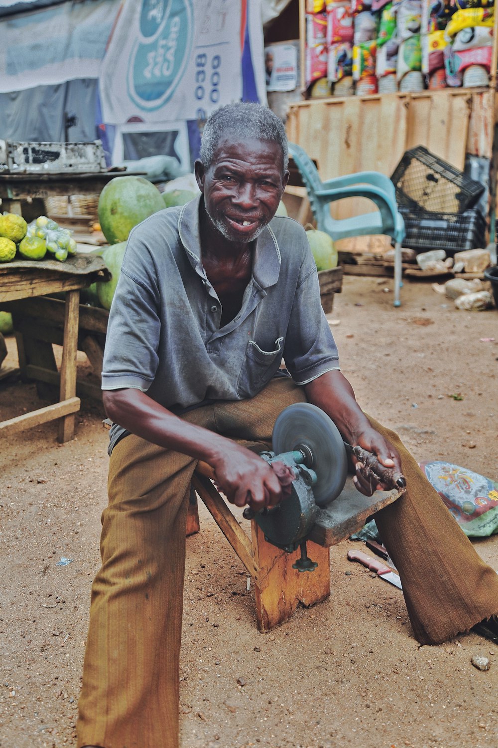 a man sitting on a bench with a shoe in his hand