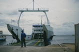 a man standing in front of a large boat