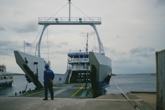 a man standing in front of a large boat