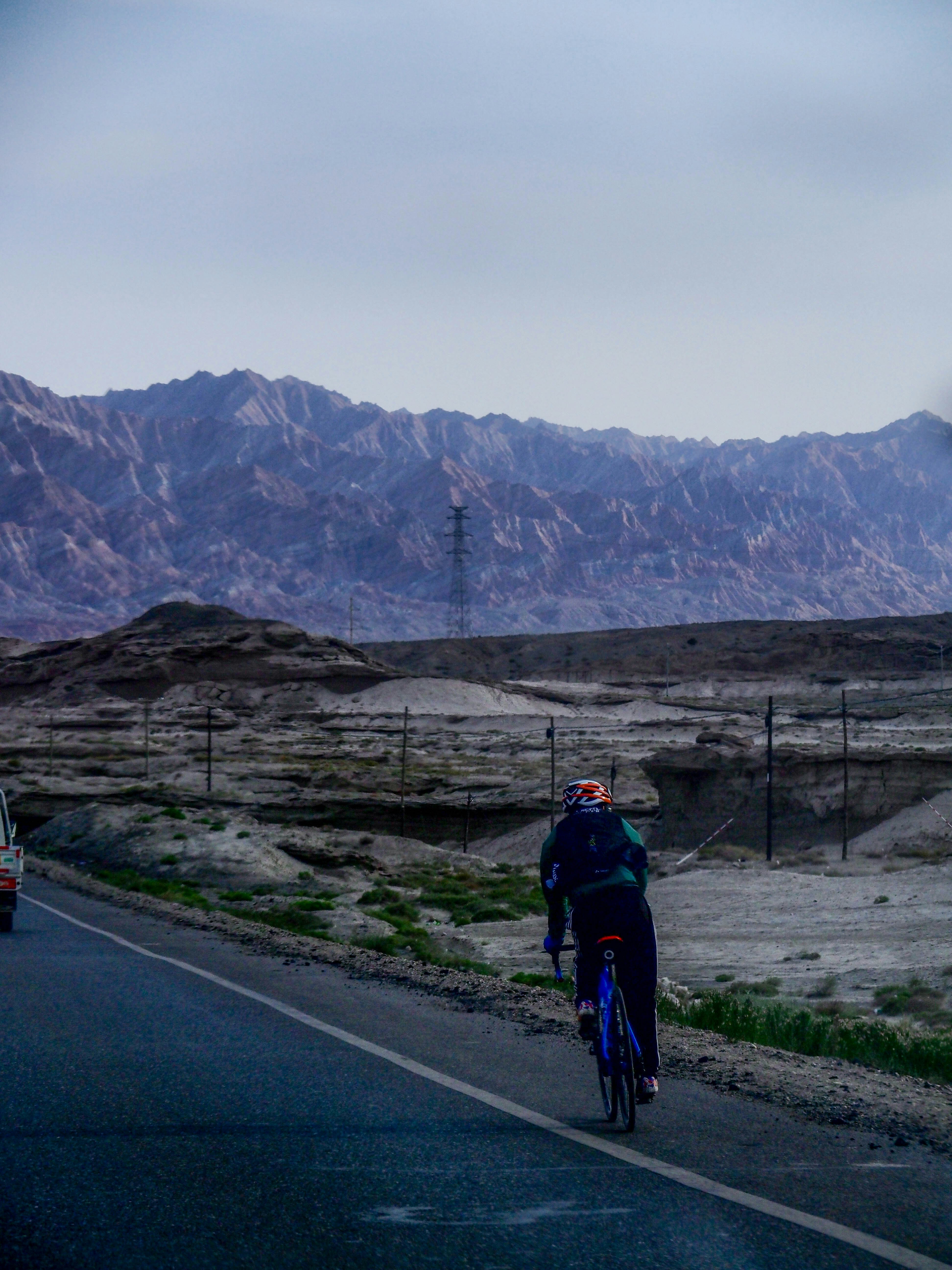 a person riding a bike down a road