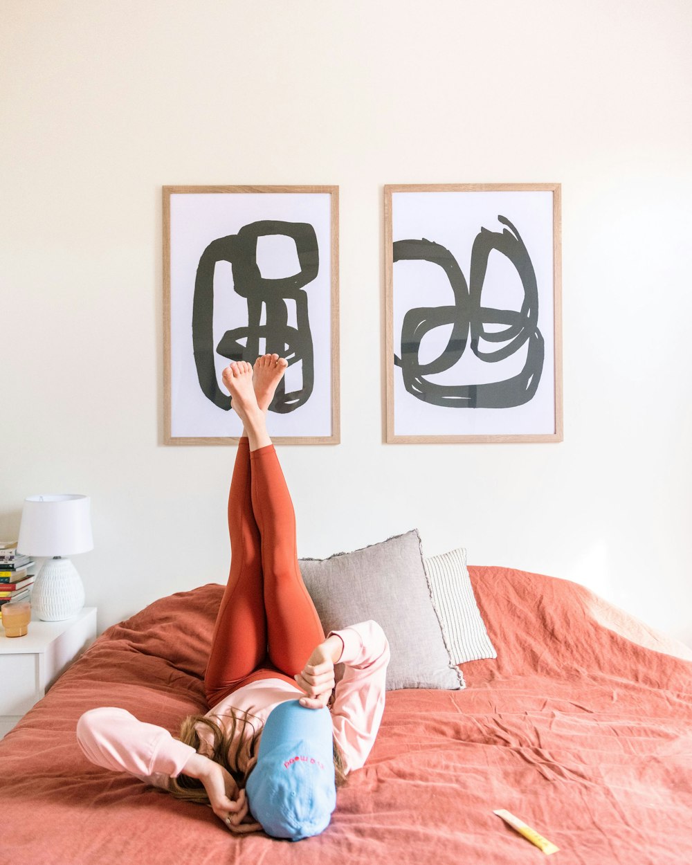 a woman laying on top of a bed in a bedroom