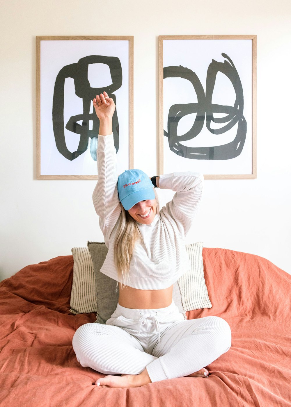 a woman sitting on top of a bed in a room