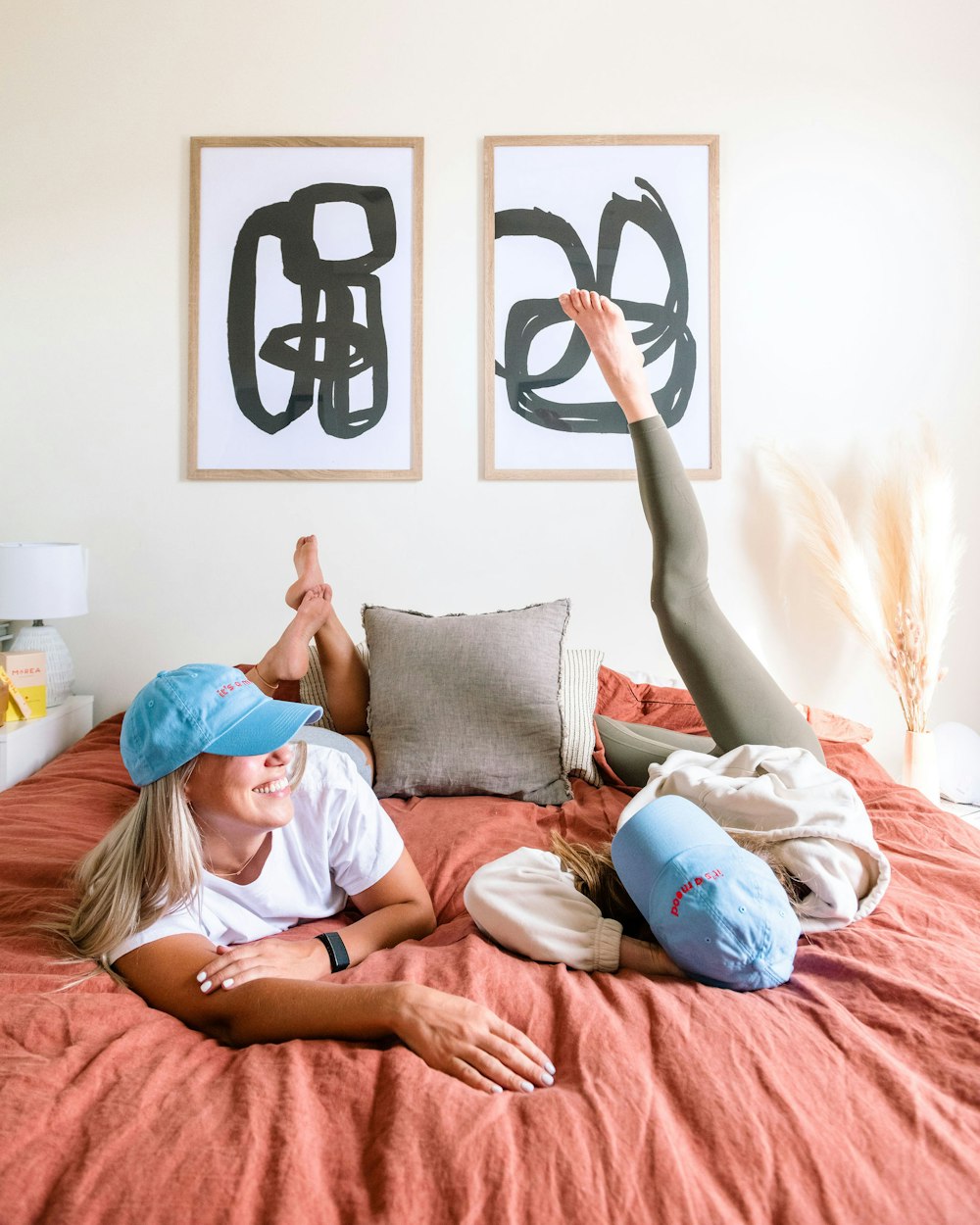 a couple of people laying on top of a bed