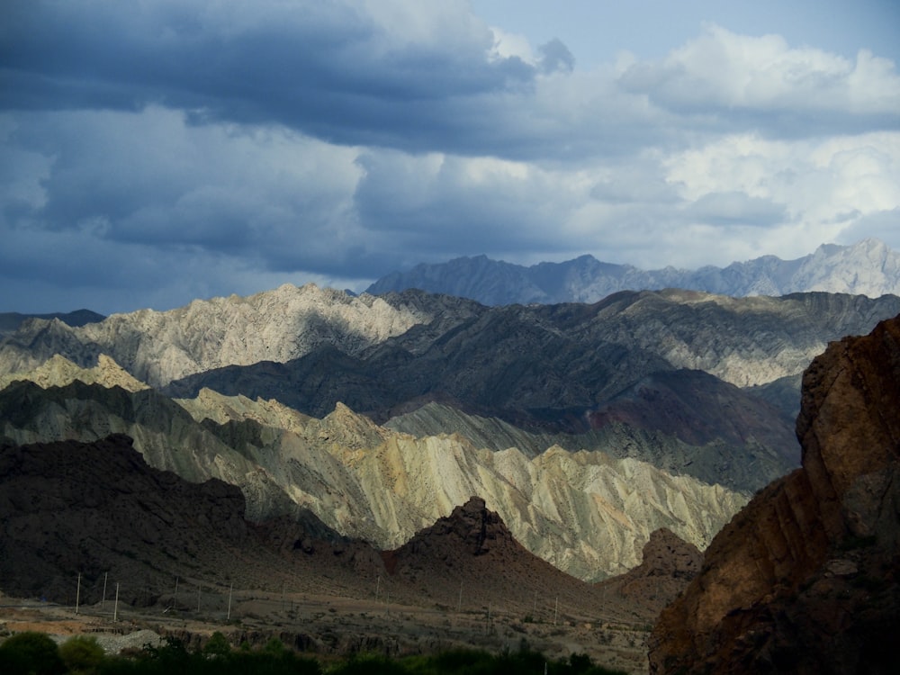 a view of a mountain range with clouds in the sky