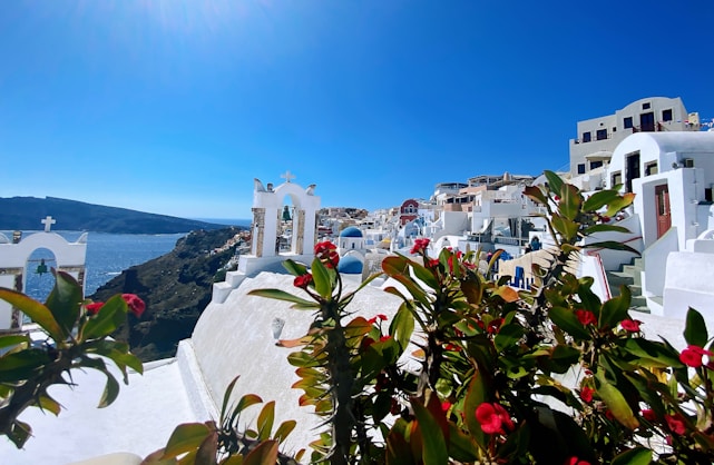 A vibrant coastal view of Lefkada with turquoise waters and traditional white houses under a clear blue sky