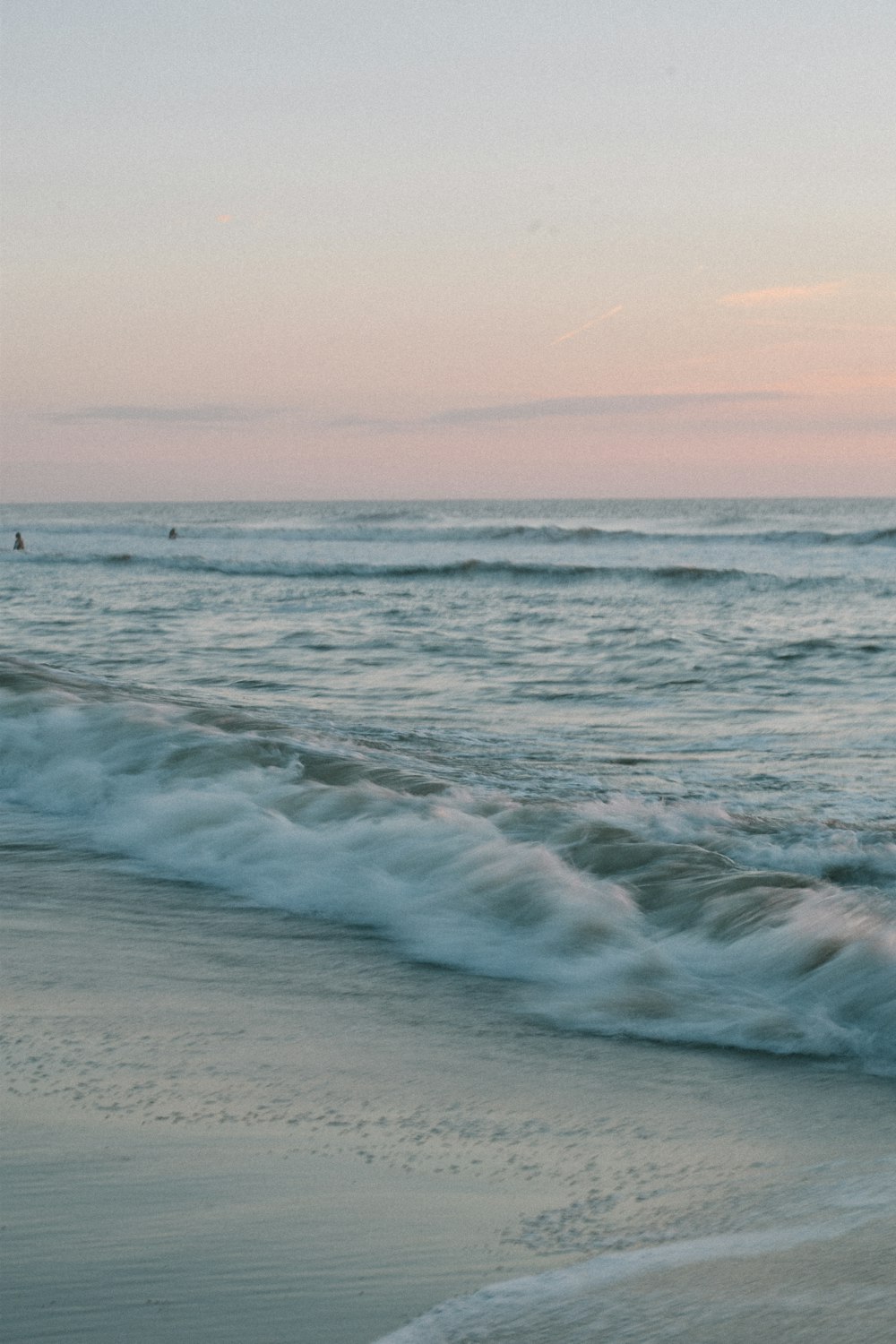 a person riding a surfboard on top of a wave