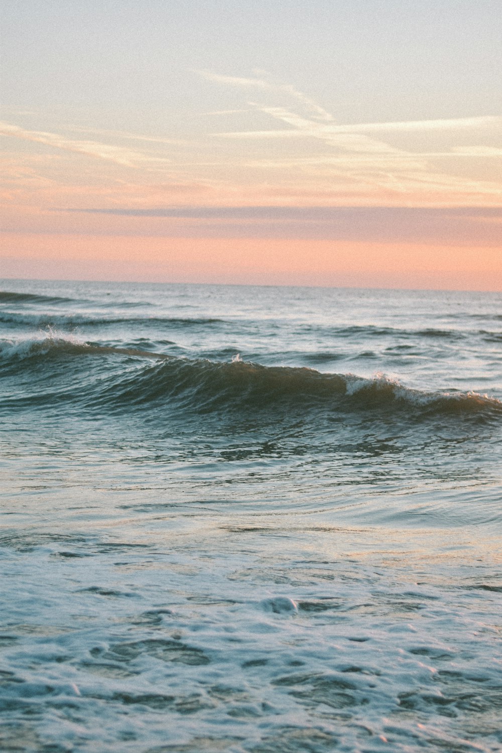 a man riding a surfboard on top of a wave in the ocean