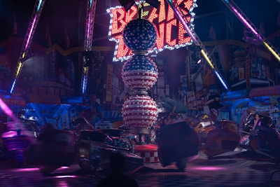 Colorful amusement rides spinning with joyful families around.