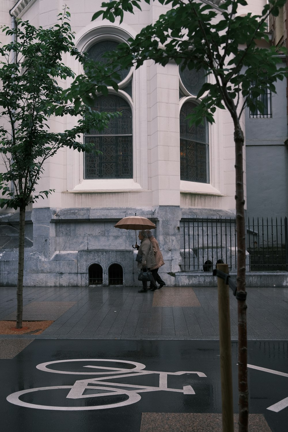 a person walking down a street with an umbrella