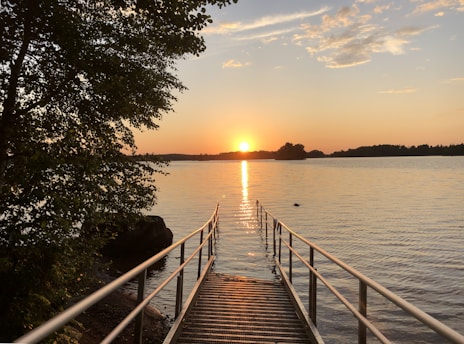 A serene view of Davis Lake surrounded by the condo buildings with the sun setting behind the trees.