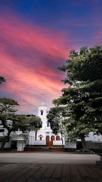 Sunset over a restored colonial building hosting tourism workshops.