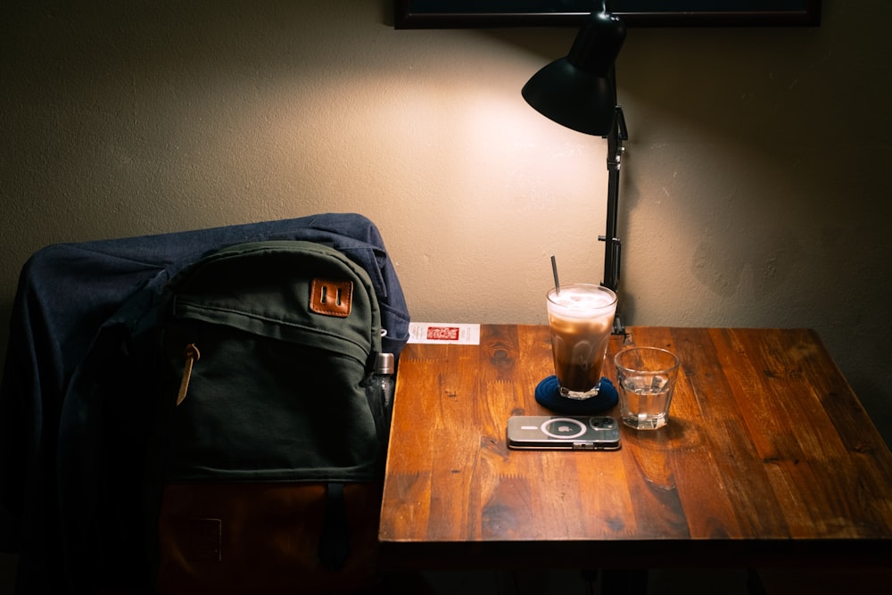 a wooden table topped with a cup of coffee