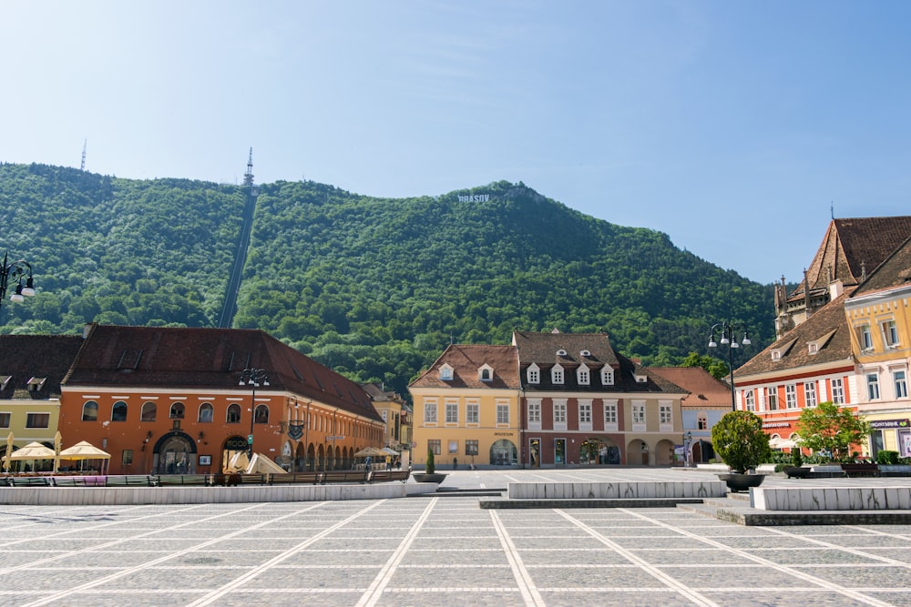 a town square with a mountain in the background