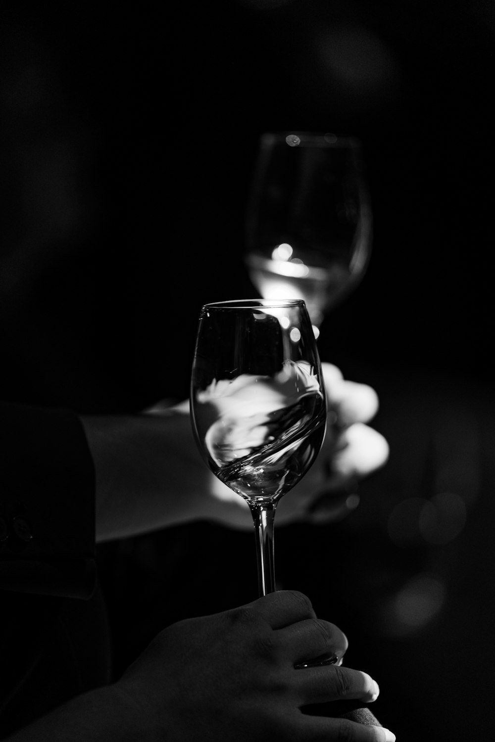 a person holding a wine glass in their hand