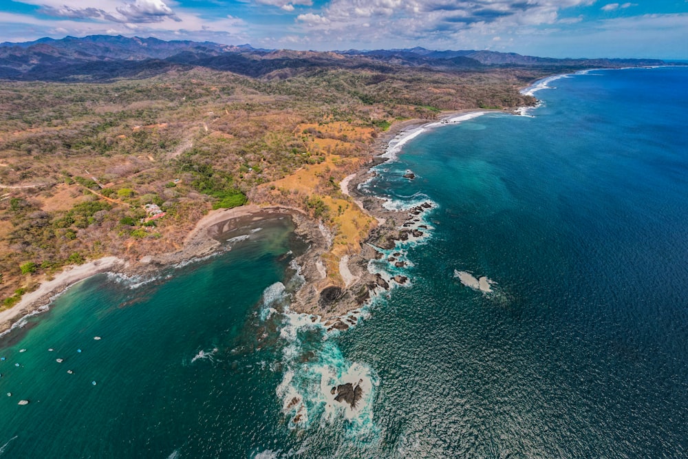 an aerial view of the ocean and land