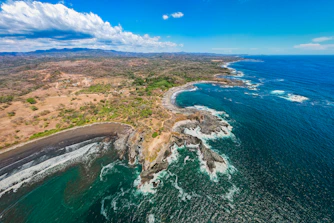 an aerial view of the coastline of a tropical island