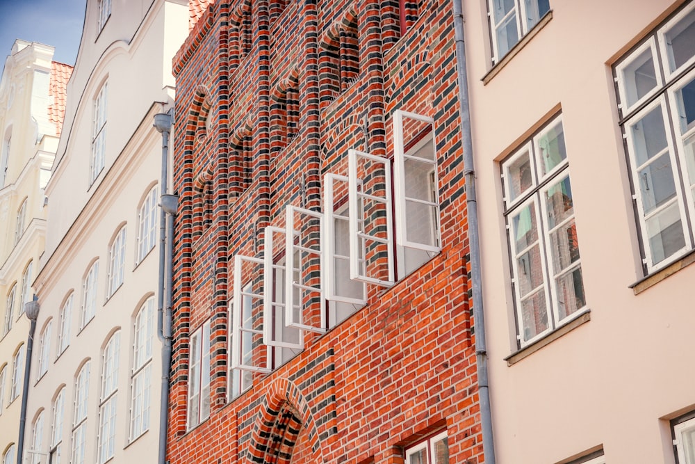 a red brick building with white windows and shutters